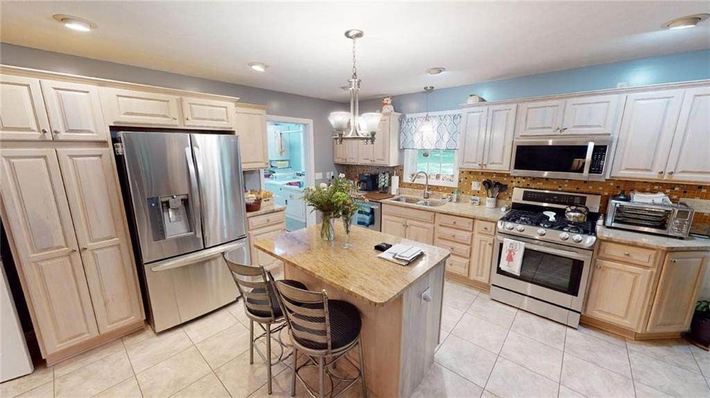 123 Hunt Road Butler, PA 16001 - Photo 5 of 44 a kitchen with stainless steel appliances a refrigerator stove microwave and cabinets