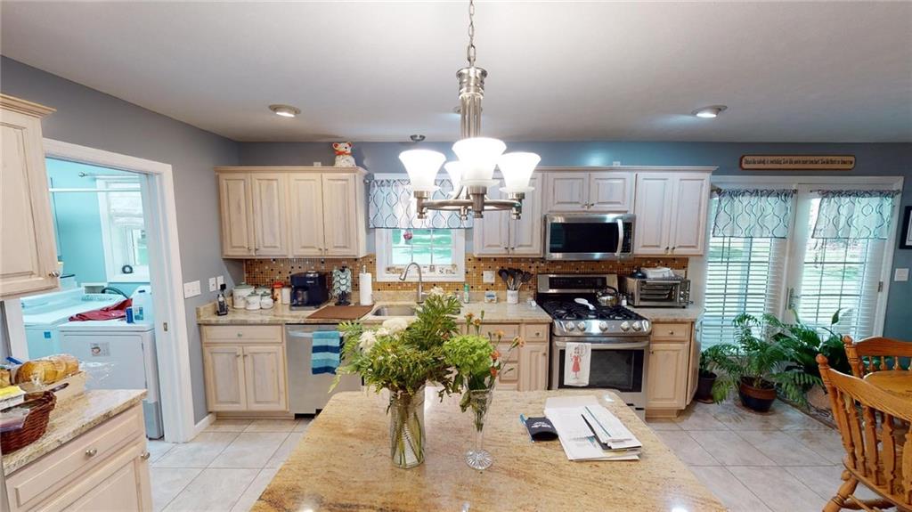 123 Hunt Road Butler, PA 16001 - Photo 10 of 44 a kitchen with counter top space appliances cabinets and a potted plant