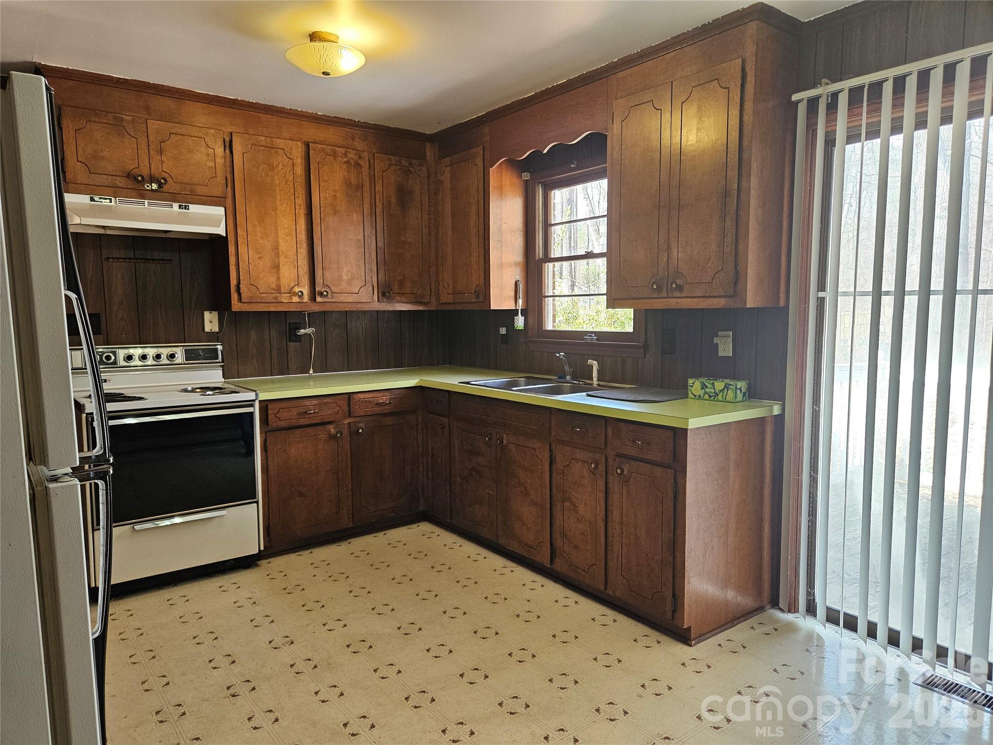 7440 Tuckaseegee Road Kannapolis, NC 28081 - Photo 2 of 17 a kitchen with a sink stove and cabinets