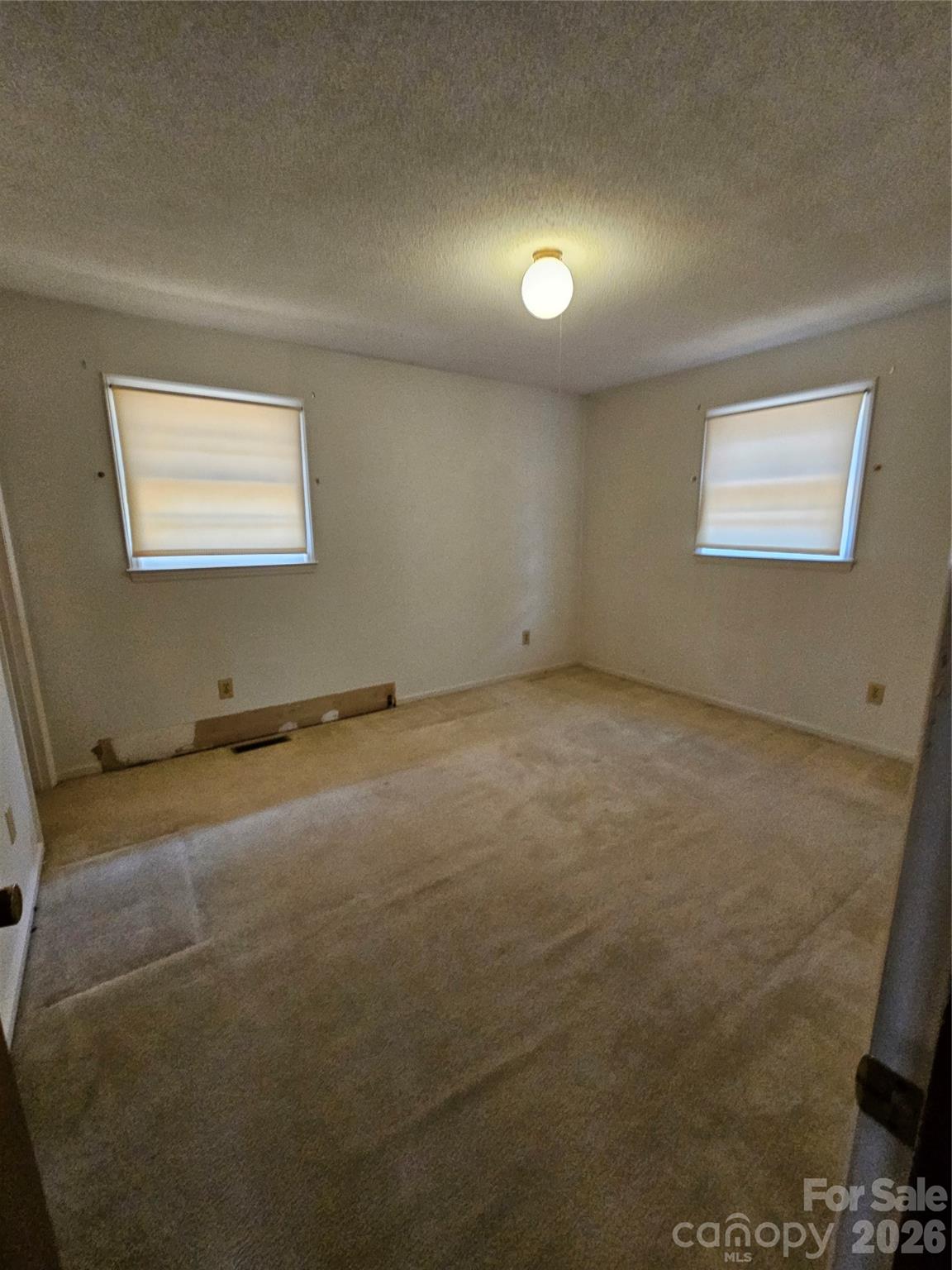 7440 Tuckaseegee Road Kannapolis, NC 28081 - Photo 8 of 17 an empty room with a empty space and a window