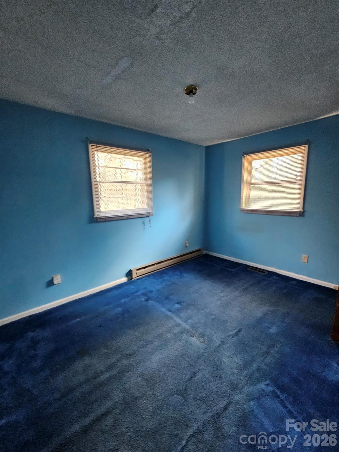 7440 Tuckaseegee Road Kannapolis, NC 28081 - Photo 9 of 17 an empty room with wooden floor and windows