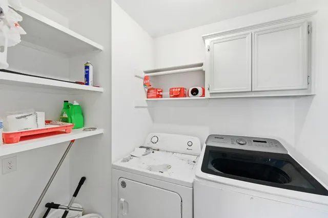 a utility room with sink dryer and washer