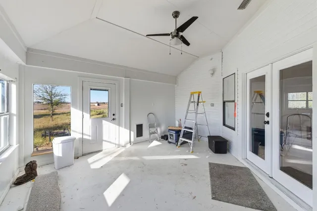 a living room with furniture and view of kitchen