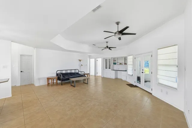 a living room with furniture and a ceiling fan