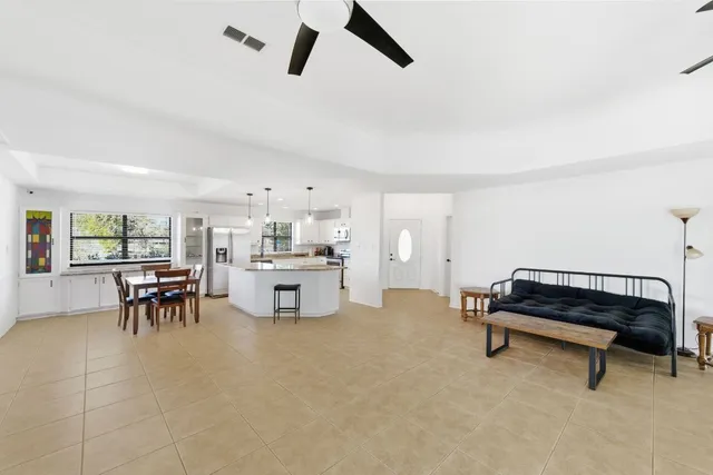 a living room with furniture and a ceiling fan