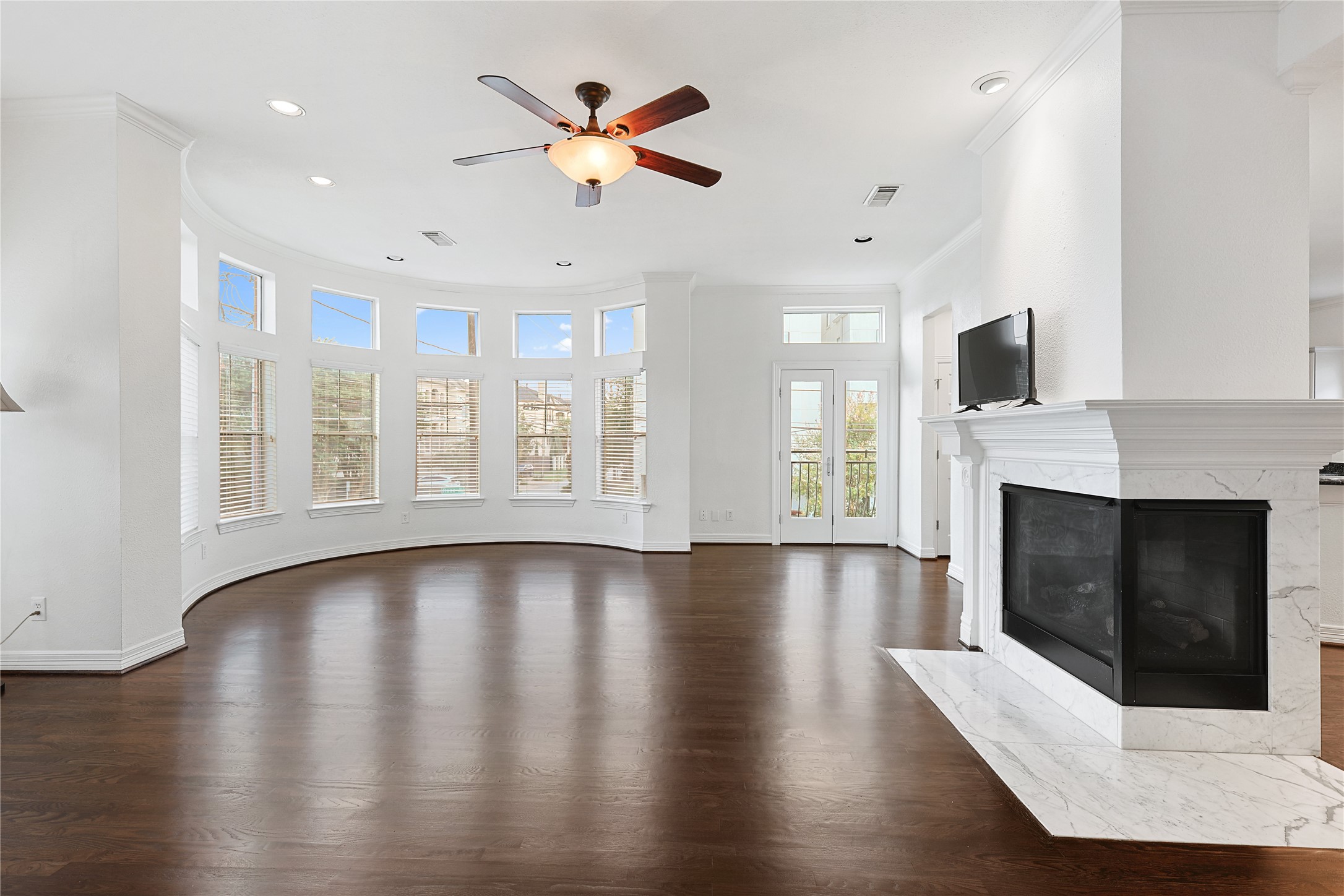 801 Knox Street Houston, TX 77007 - Photo 12 of 33 an empty room with windows fireplace and wooden floor
