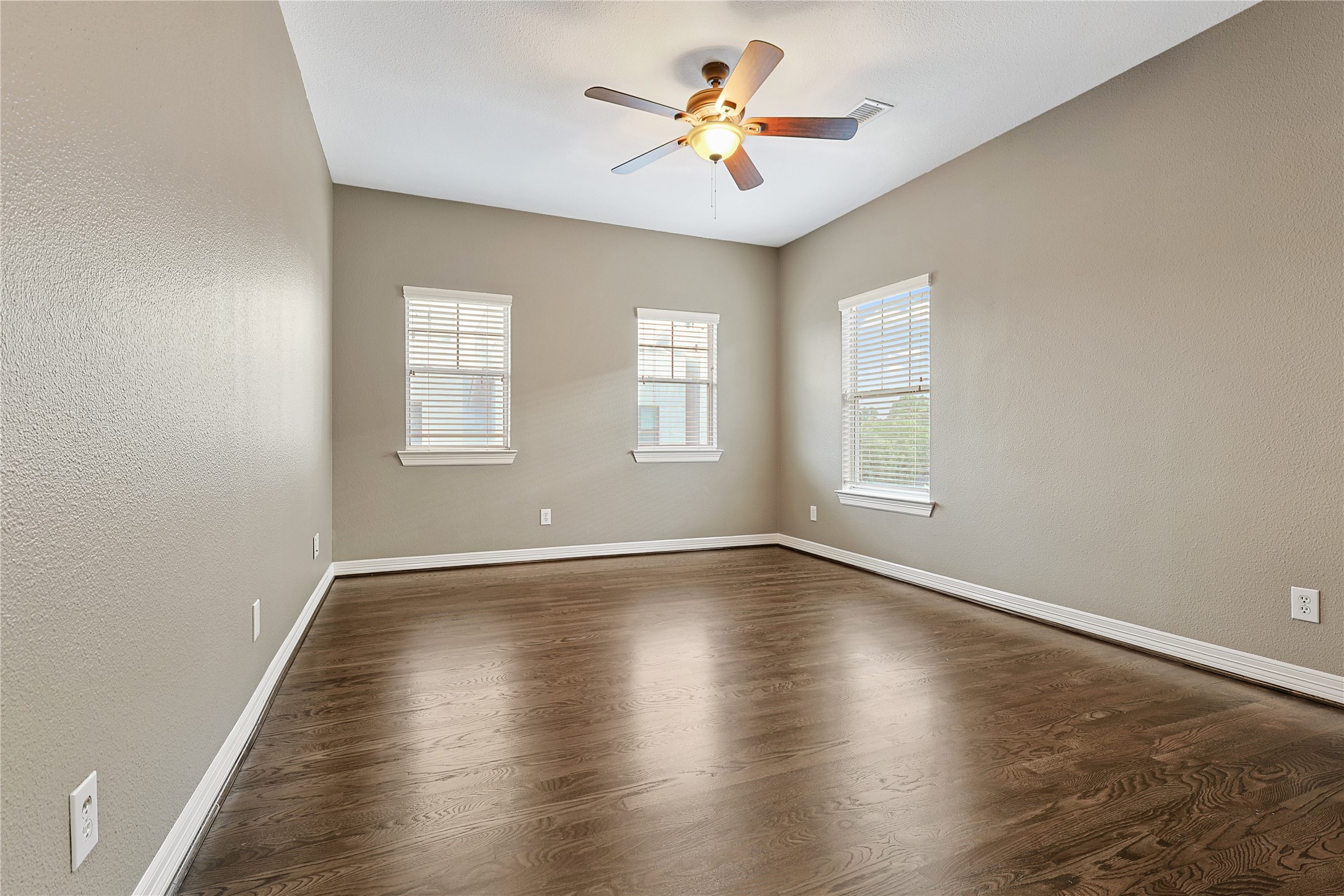 801 Knox Street Houston, TX 77007 - Photo 20 of 33 a view of an empty room with window and wooden floor