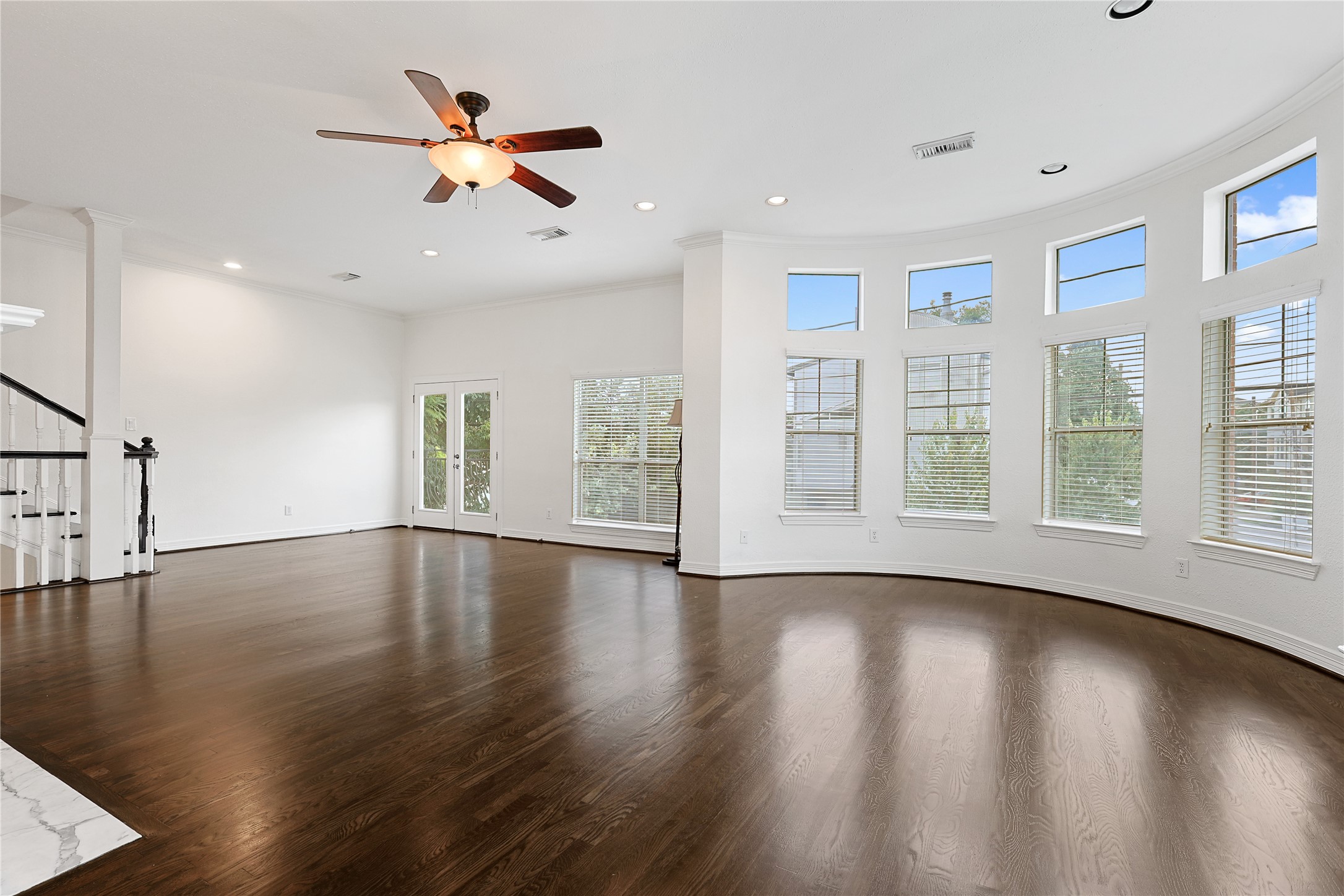 801 Knox Street Houston, TX 77007 - Photo 6 of 33 a view of an empty room with wooden floor and a window