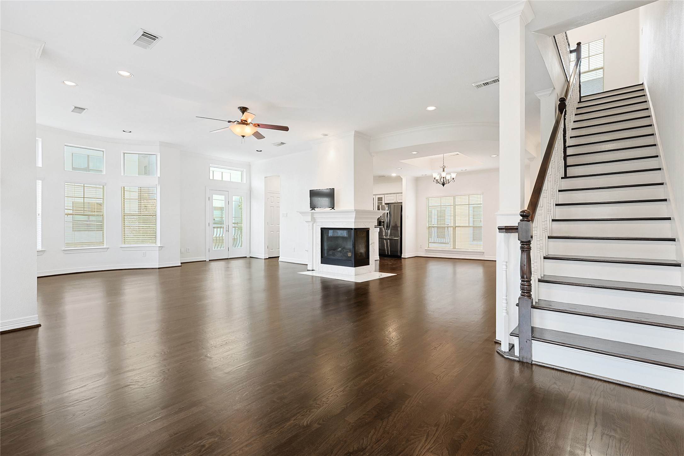 801 Knox Street Houston, TX 77007 - Photo 7 of 33 an open space with wooden floor and staircase