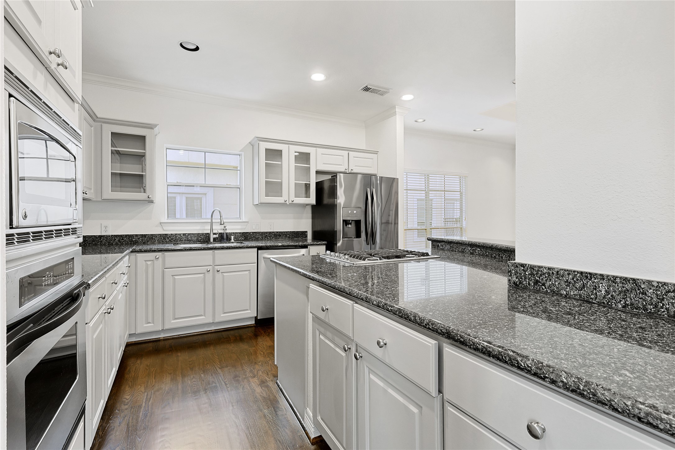 801 Knox Street Houston, TX 77007 - Photo 8 of 33 a kitchen with granite countertop a sink stainless steel appliances and white cabinets