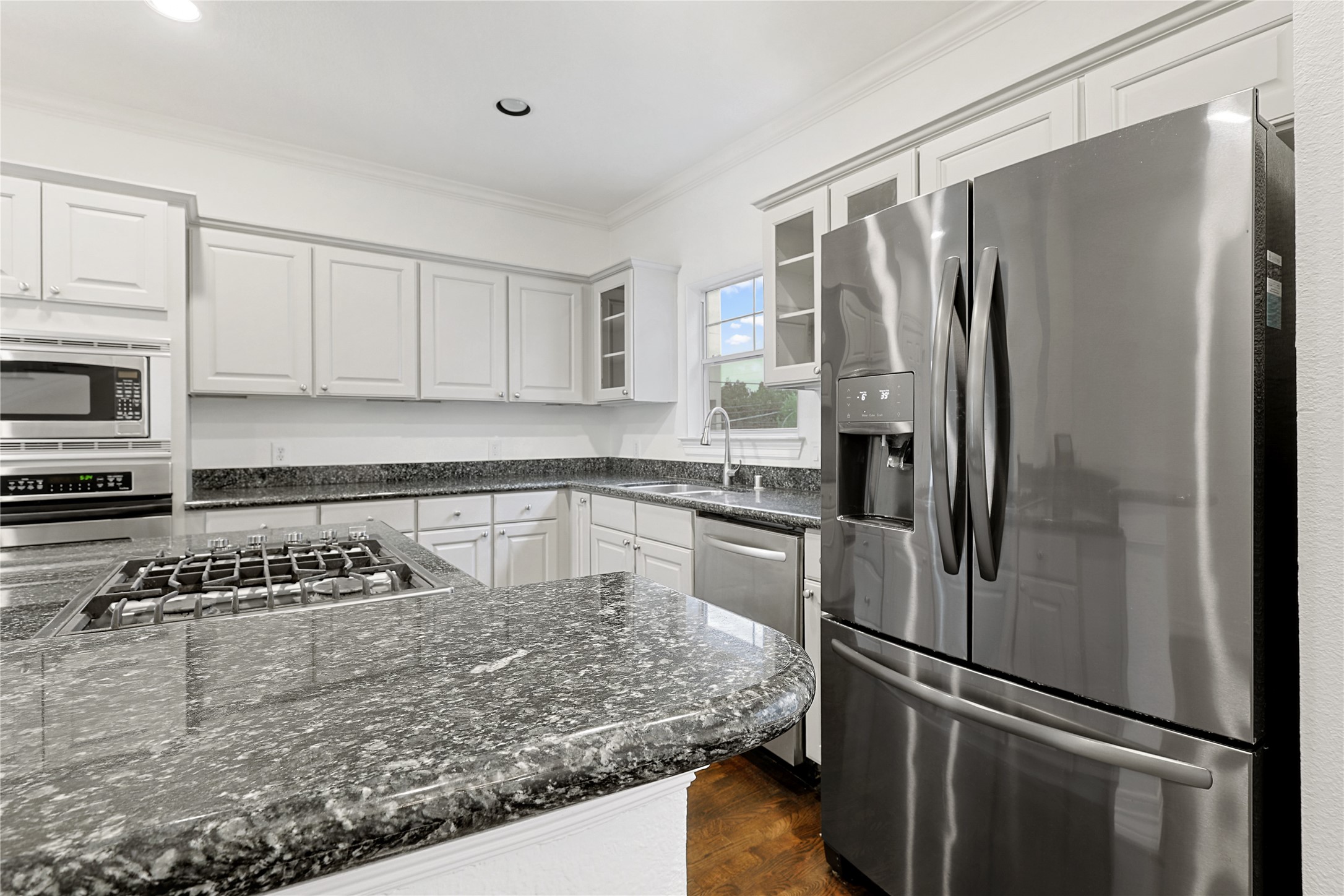 801 Knox Street Houston, TX 77007 - Photo 9 of 33 a kitchen with stainless steel appliances granite countertop a refrigerator and a stove top oven