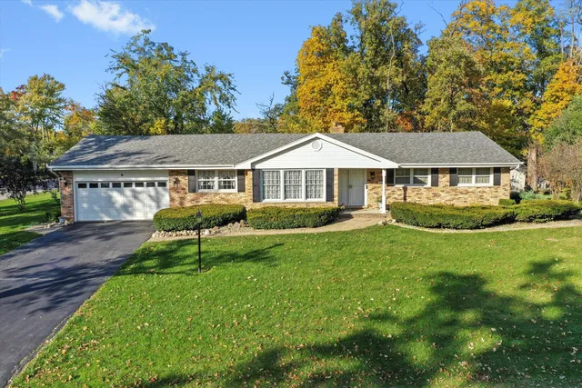 a view of a house with a yard and sitting area