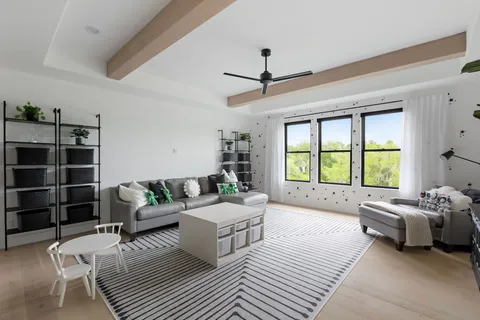 a bedroom with furniture and a large window