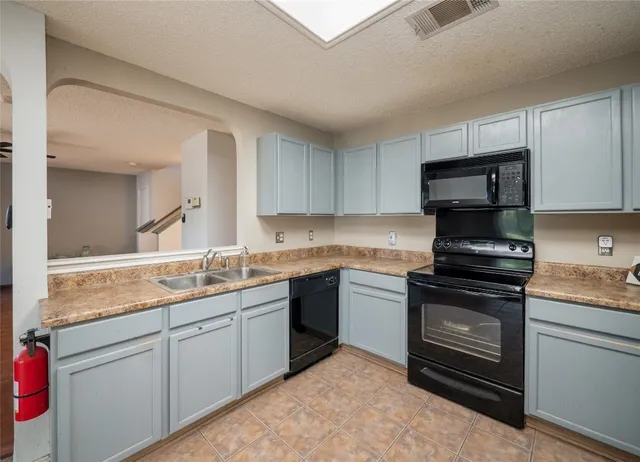 a kitchen with a sink stove and microwave