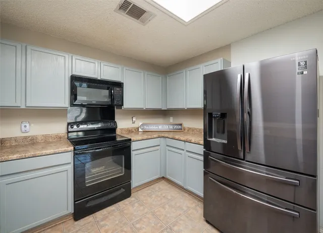 a kitchen with a refrigerator stove and sink
