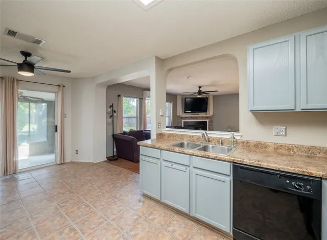 a kitchen with a sink and cabinets
