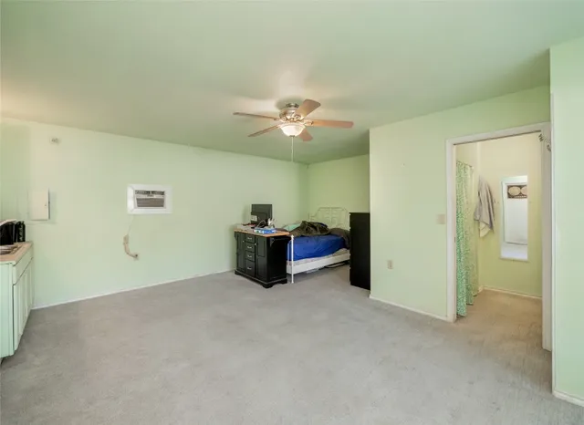 a view of an empty room with a ceiling fan