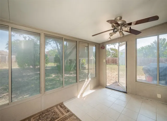 a view of a room with window and ceiling fan