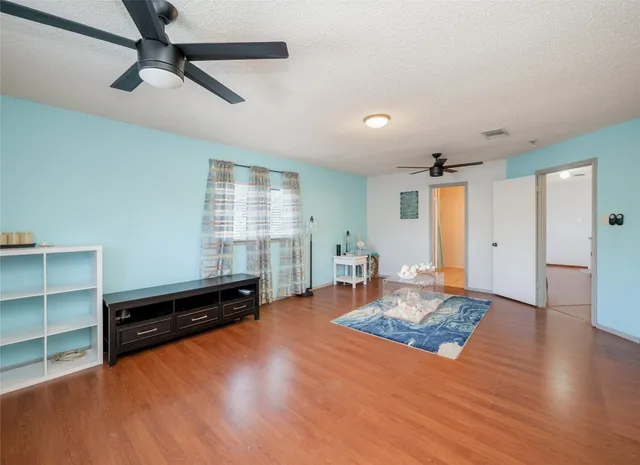 a living room with furniture window and wooden floor