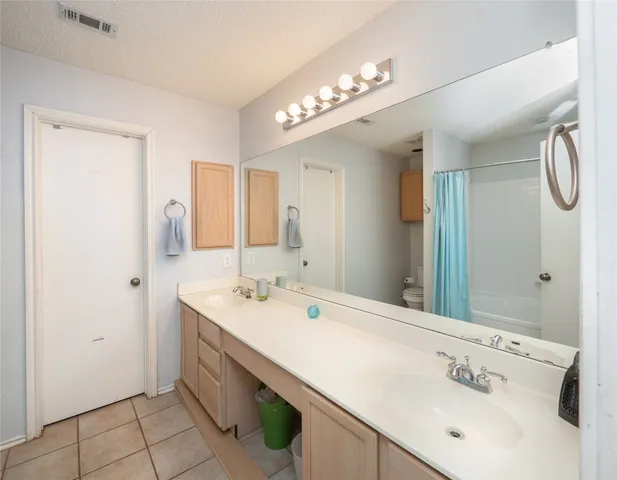 a bathroom with a sink double vanity and a mirror