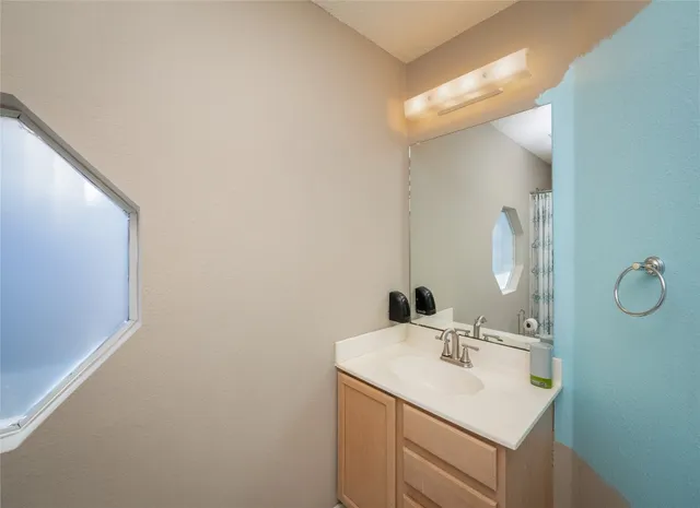 a bathroom with a sink and a mirror