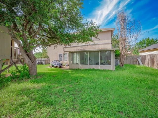 a view of a house with a backyard
