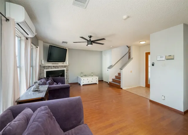 a living room with furniture a fireplace and a flat screen tv