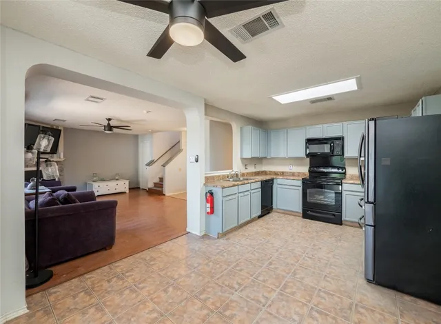 a kitchen with stainless steel appliances kitchen island a refrigerator sink and stove