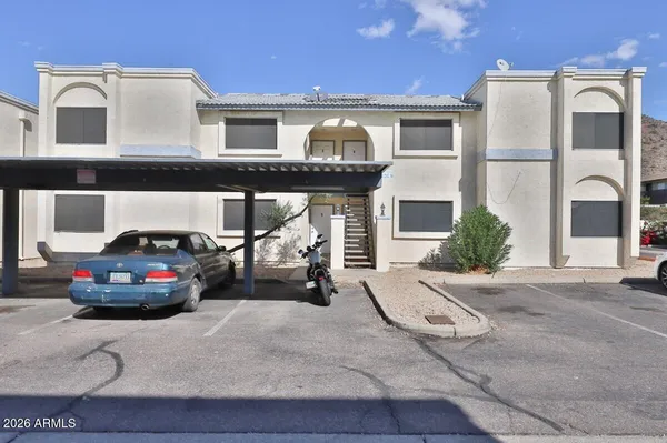 a car parked in front of a white house