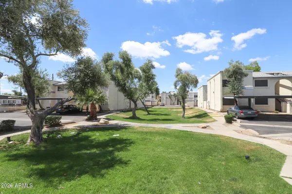 a view of building with yard and trees