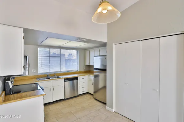 a kitchen with stainless steel appliances granite countertop a sink a stove and a microwave