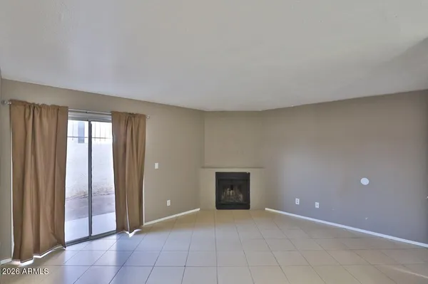 a view of an empty room with a fireplace