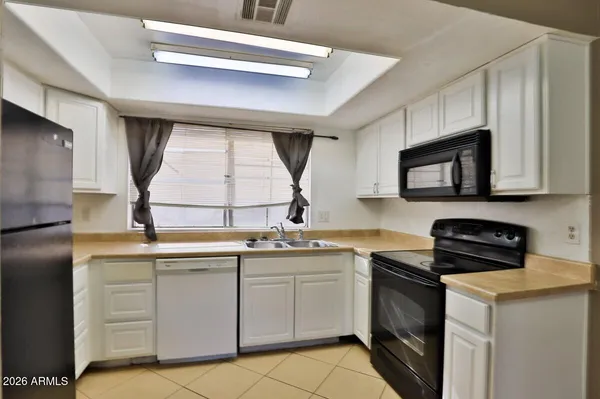 a kitchen with a sink stove and microwave