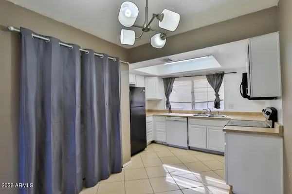 a kitchen with stainless steel appliances granite countertop a sink and cabinets