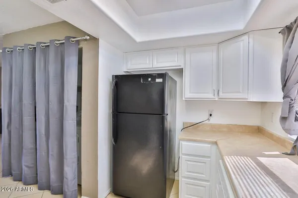a kitchen with a refrigerator and cabinets