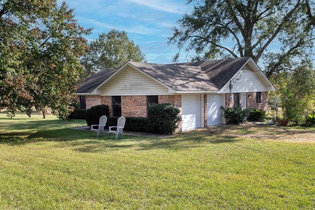 15377 County Road 1134 Tyler, TX 75709 - Photo 3 of 16 a view of a house with a yard potted plants and a large tree