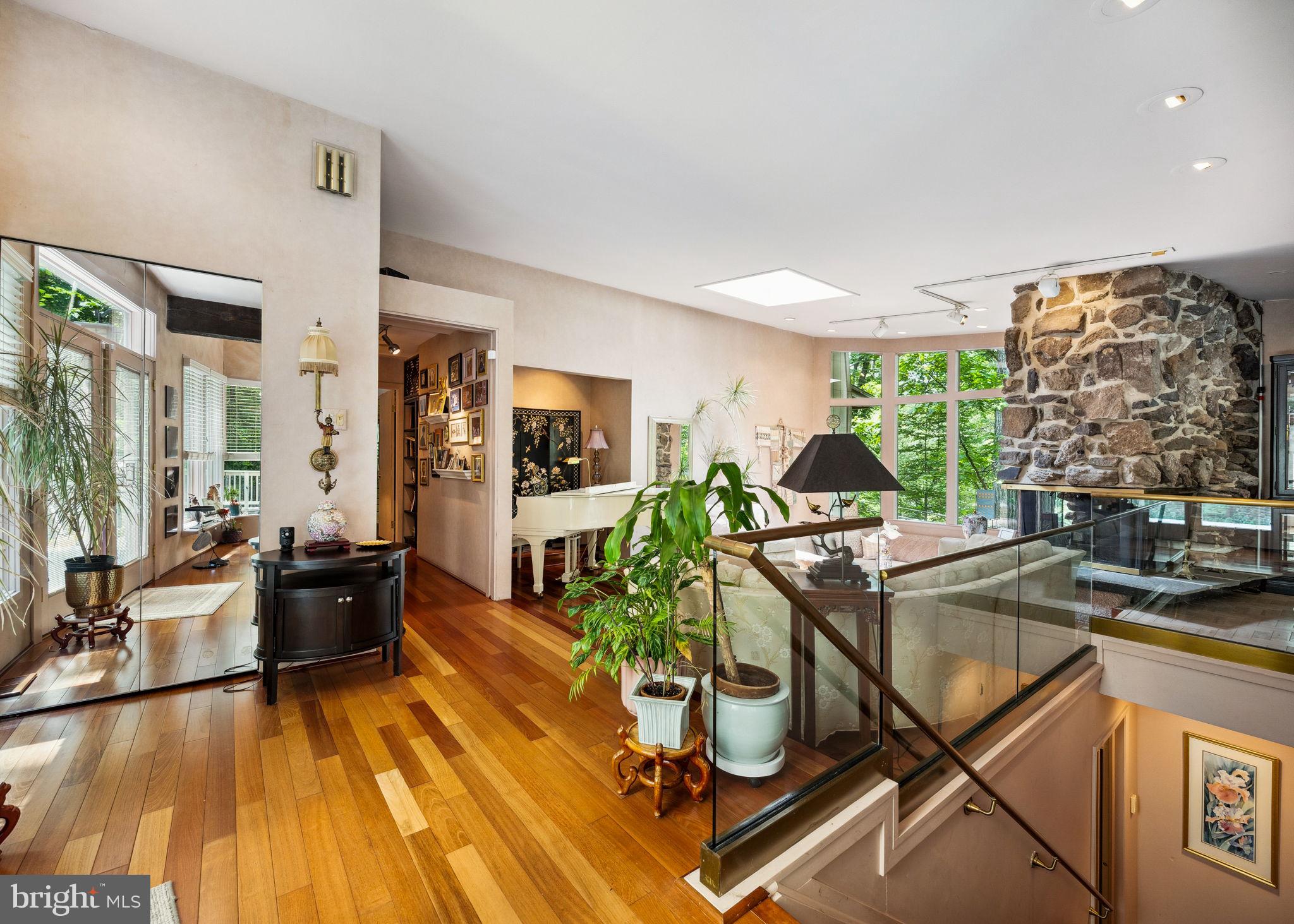 100 Pugh Road Wayne, PA 19087 - Photo 3 of 57 a living room with furniture a wooden floor and next to a window