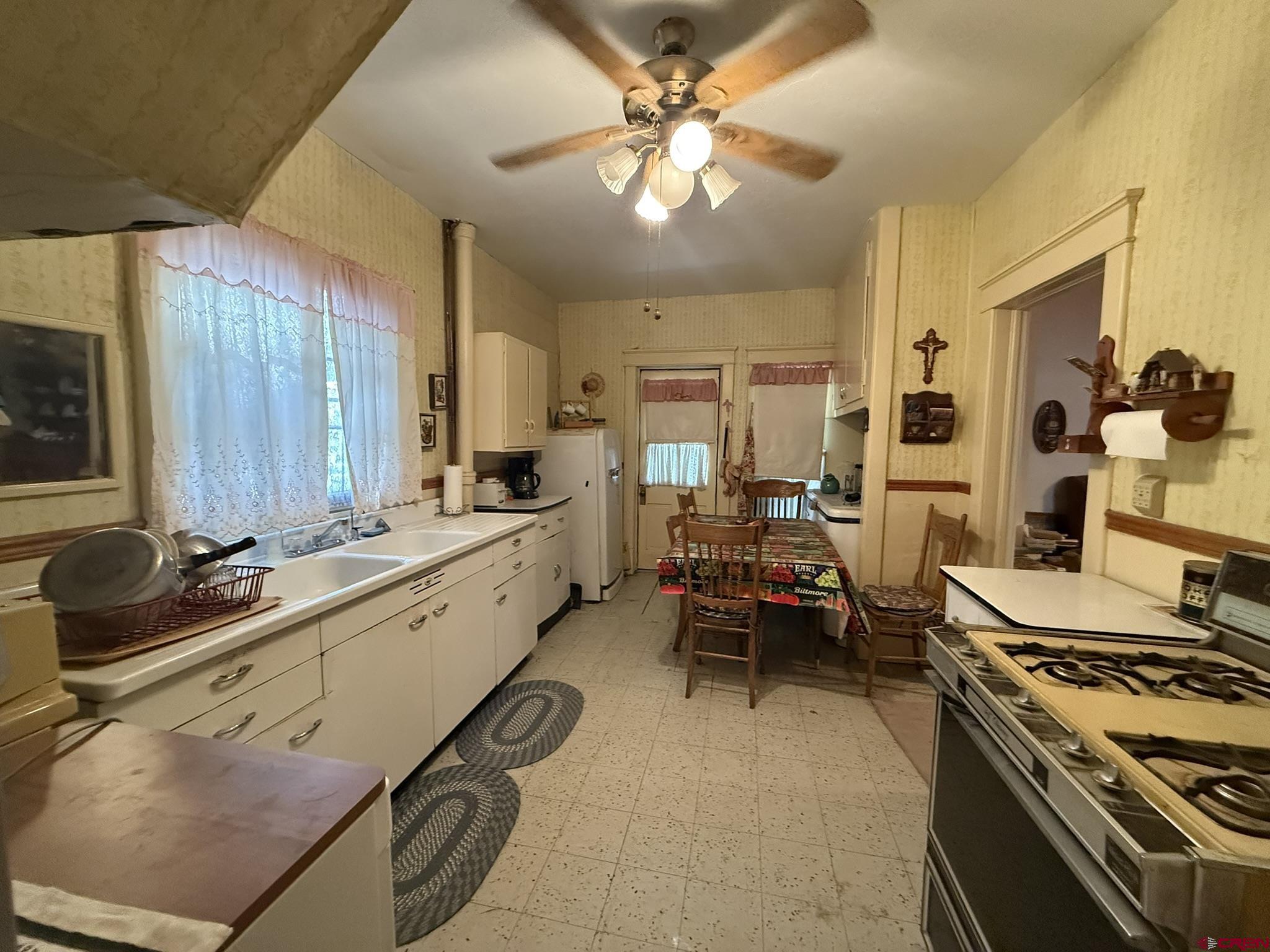 613 3rd Street Paonia, CO 81428 - Photo 12 of 33 a large kitchen with a table chairs stove and cabinets