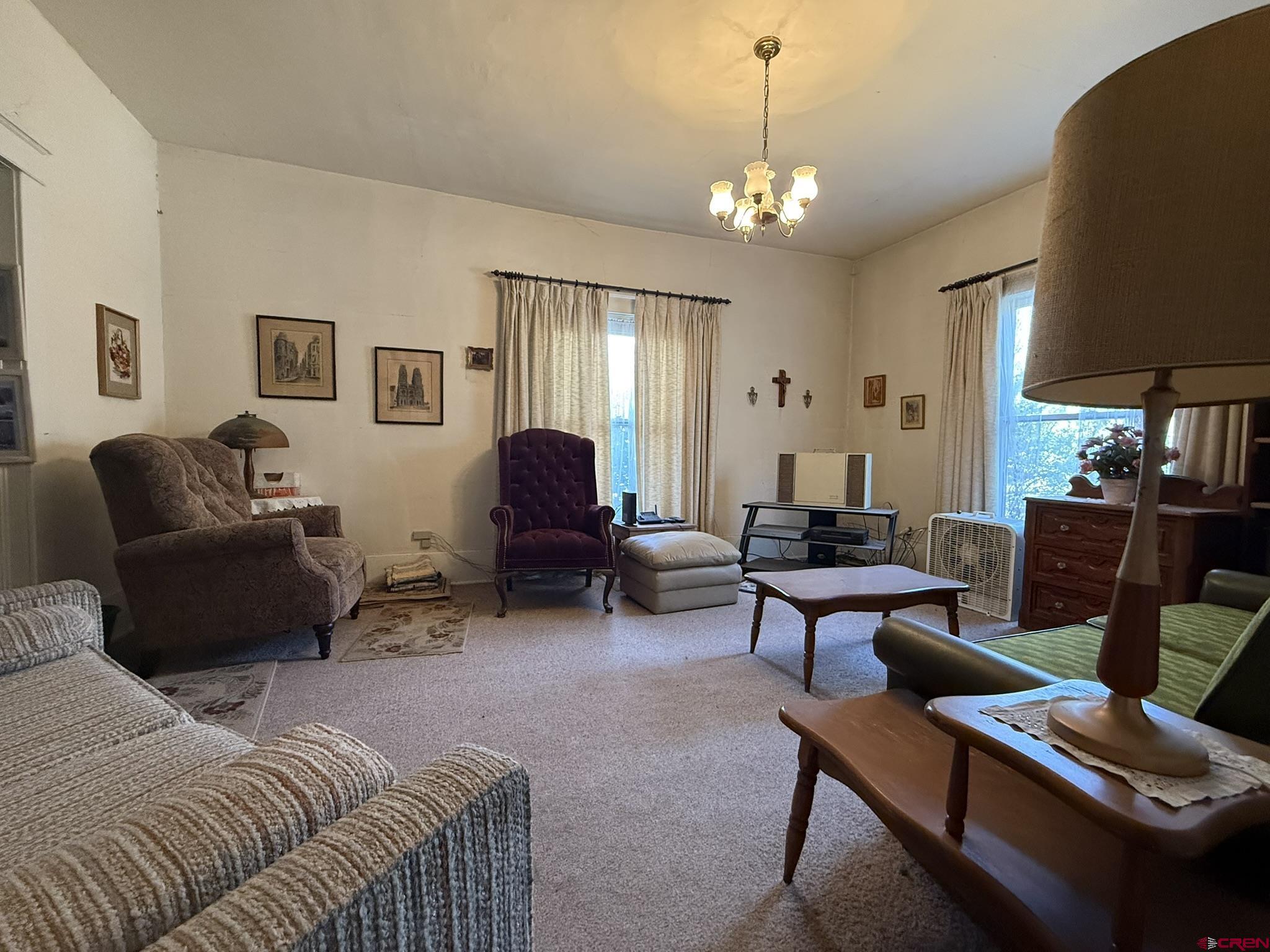 613 3rd Street Paonia, CO 81428 - Photo 34 of 44 a living room with furniture a lamp and a chandelier