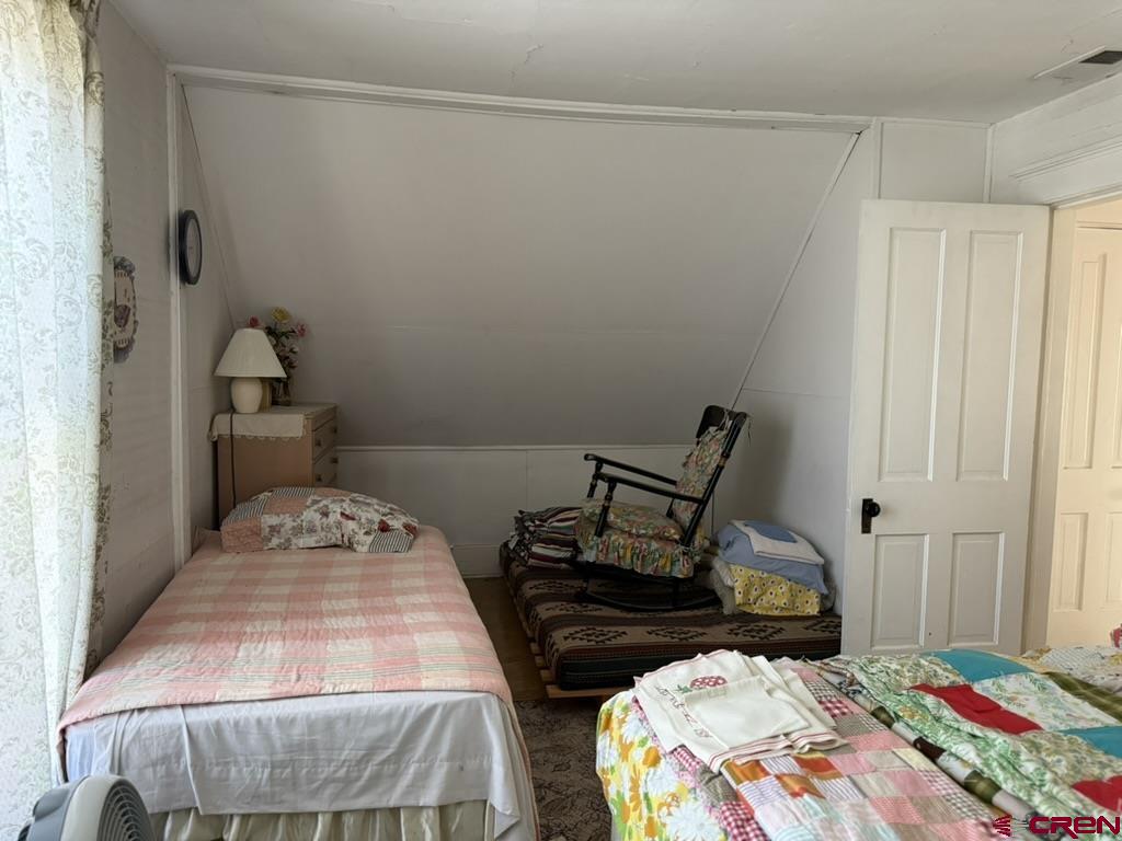 613 3rd Street Paonia, CO 81428 - Photo 36 of 44 a bedroom that has a bed and a chair in it