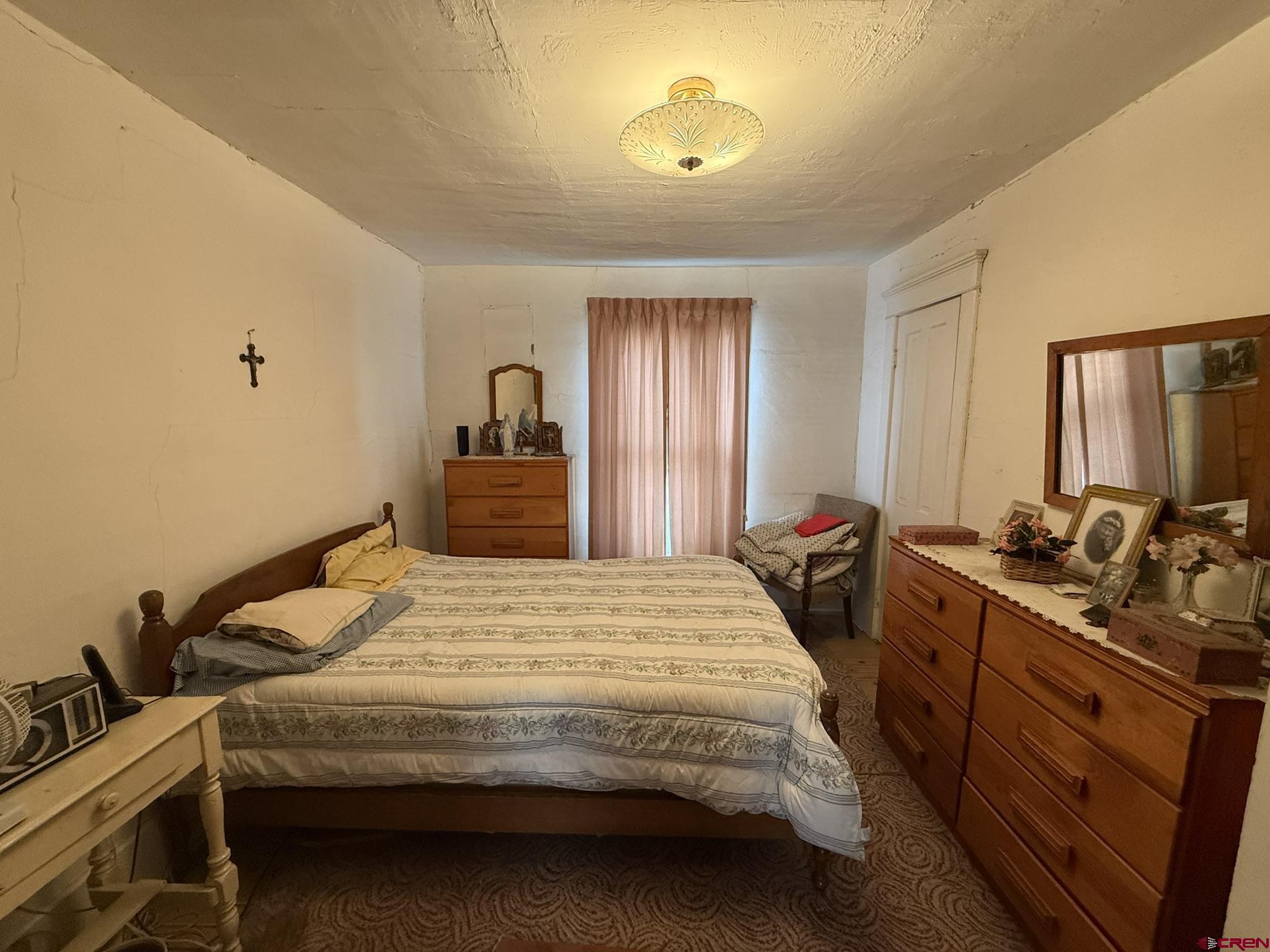 613 3rd Street Paonia, CO 81428 - Photo 37 of 44 a bedroom with a bed and a dresser with mirror