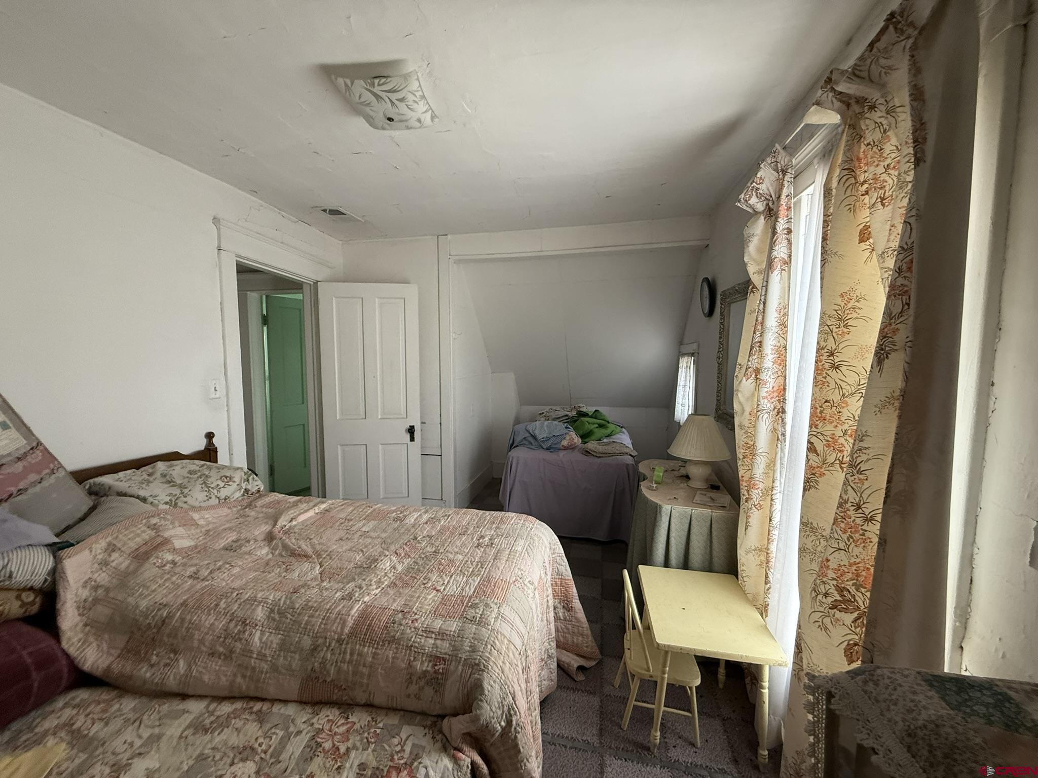 613 3rd Street Paonia, CO 81428 - Photo 39 of 44 a bedroom with a bed and a window