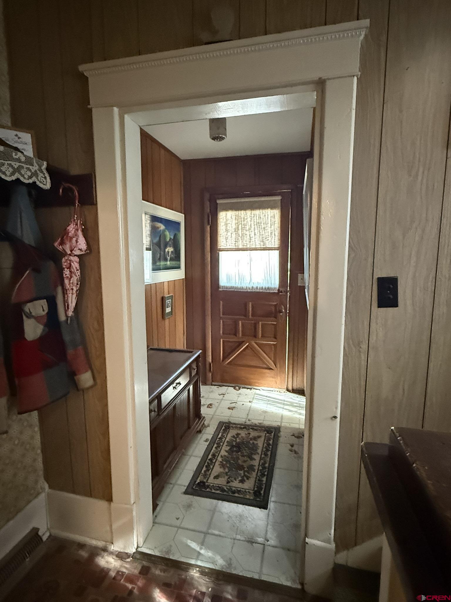 613 3rd Street Paonia, CO 81428 - Photo 6 of 44 a view of a hallway with wooden floor and living room