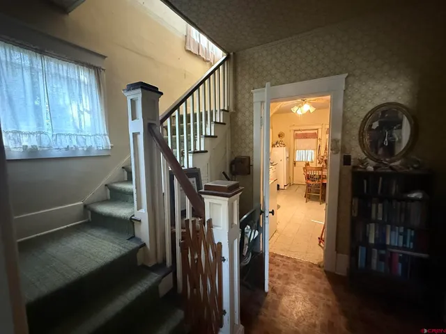 a view of entryway and hall with wooden floor