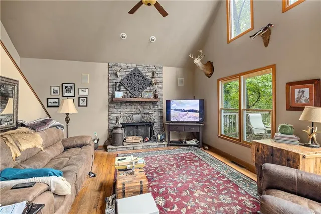 a living room with furniture large window and a fireplace