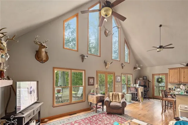 a living room with furniture a flat screen tv and a window