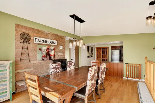 a dining room with wooden floor and large window