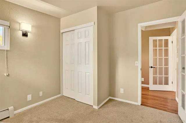 an empty room with windows and closet