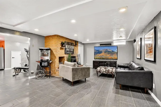 a living room with furniture gym equipment and a view of living room
