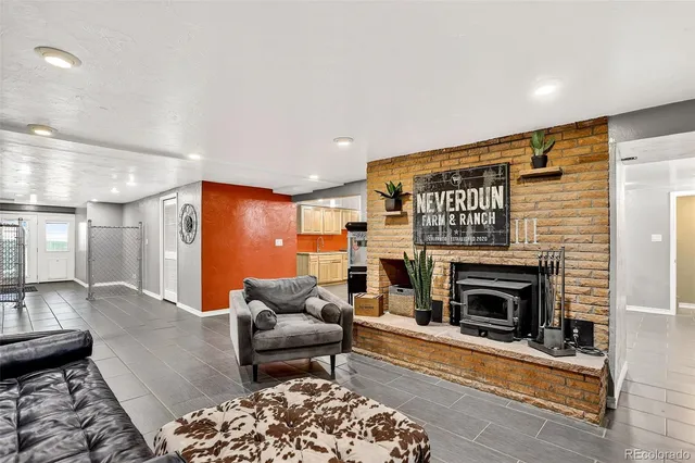 a living room with furniture a rug and a fireplace